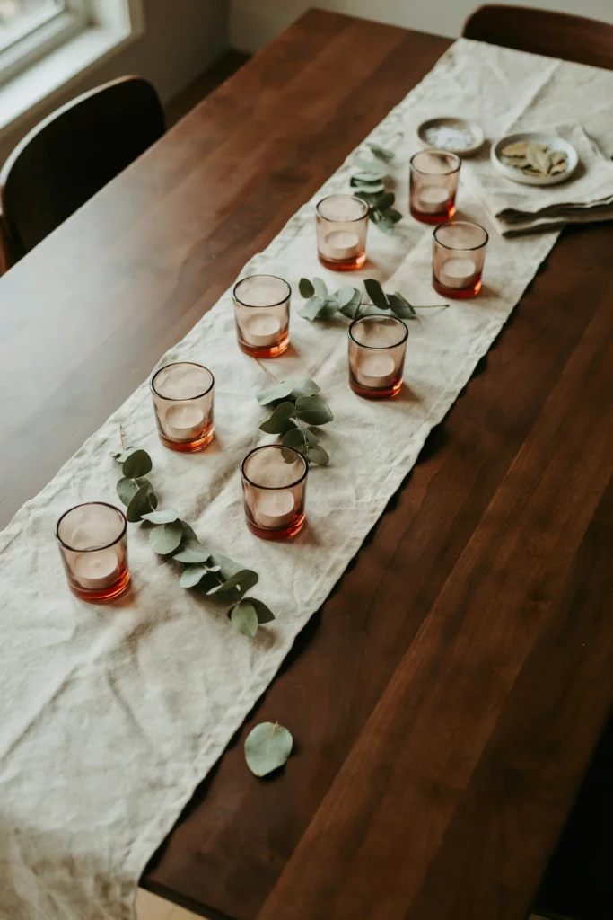 A Low Linen Runner with Scattered Votives