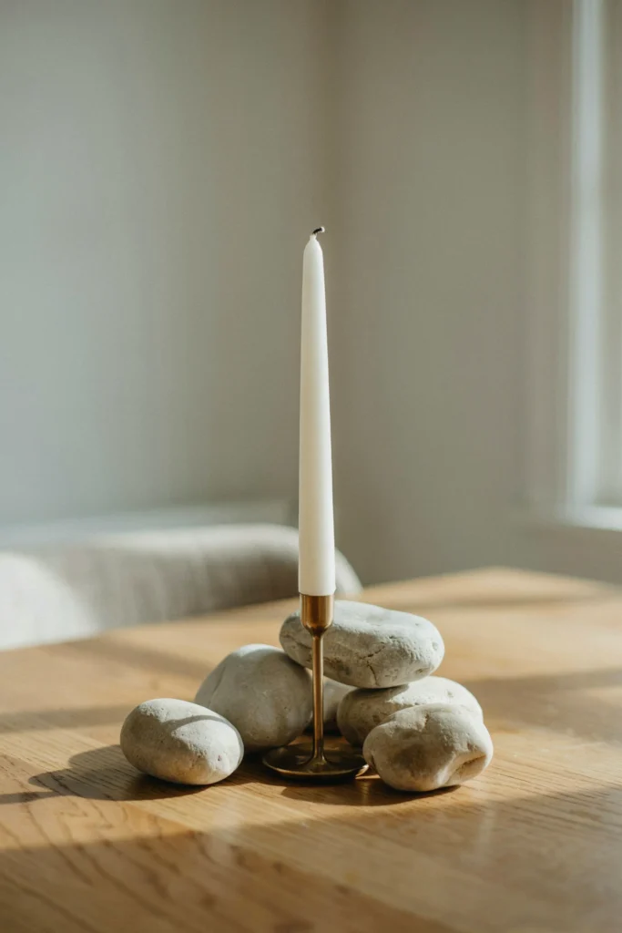 Stacked River Stones with a Candle